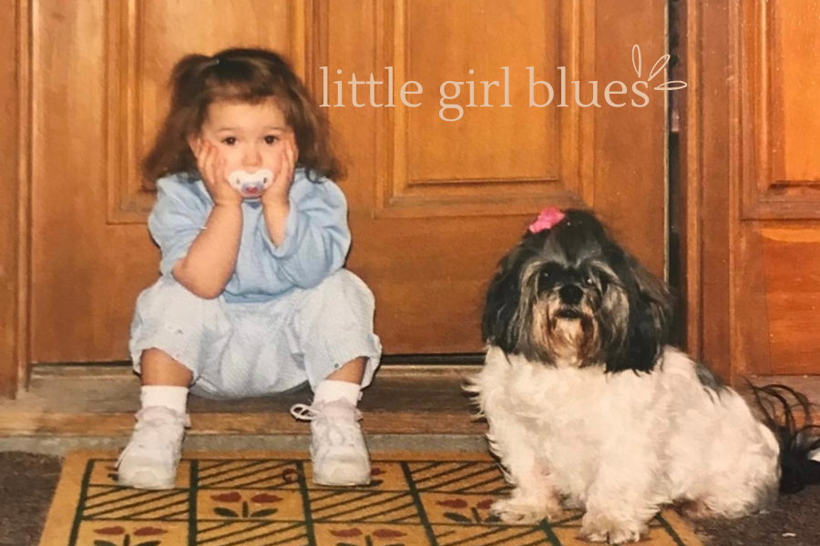 a child on the doorstep with her dog, little girl