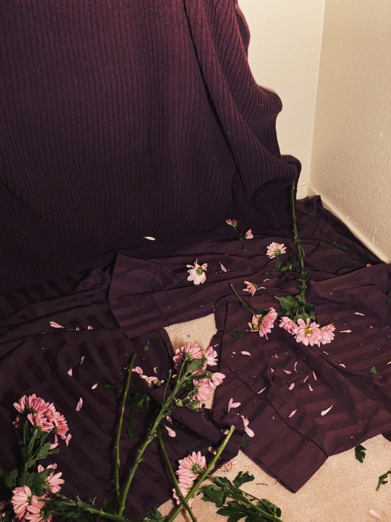 flowers and petals on purple pillowcases and blankets