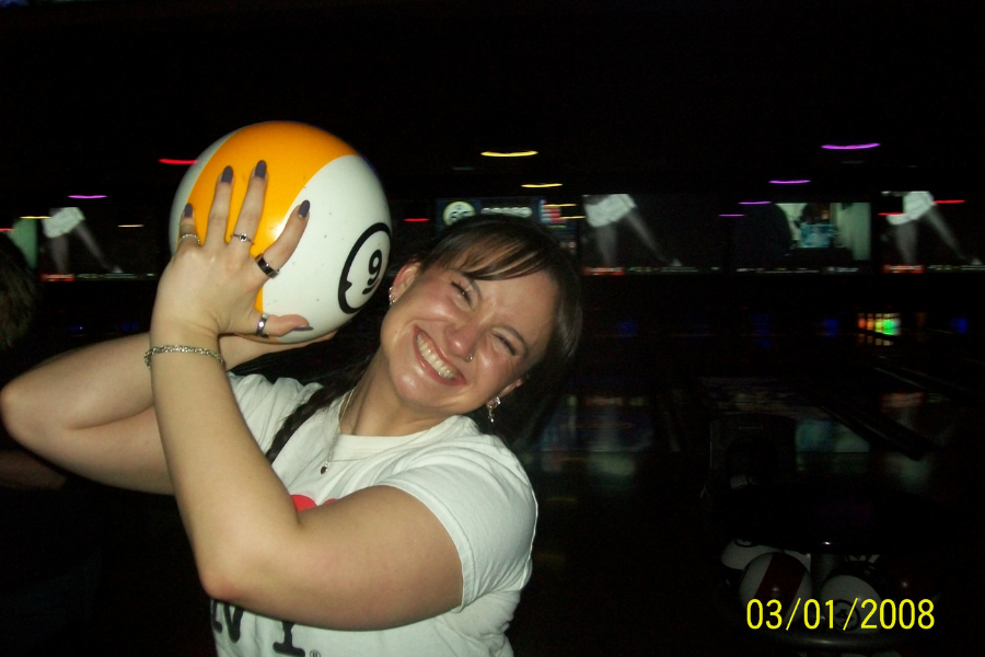 girl smiling with bowling ball, smile lines