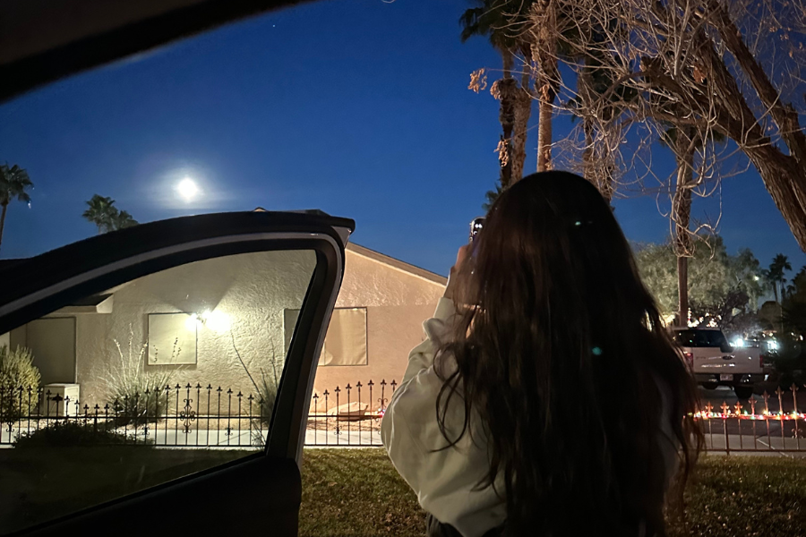 girl taking a picture of the moon