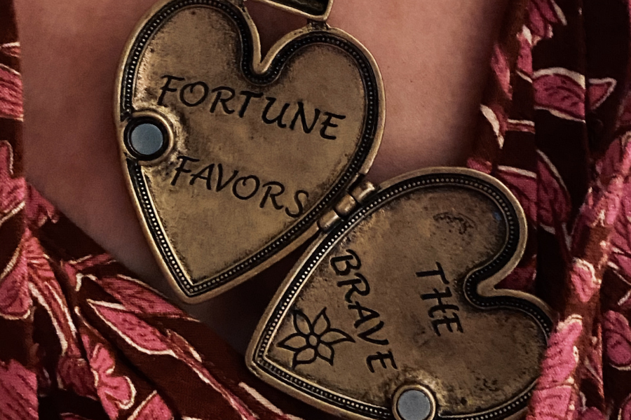 necklace that reads, "fortune favors the brave", march