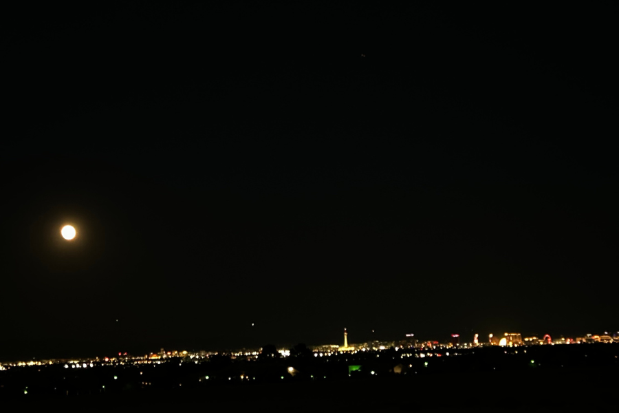 picture of a full moon and the Las Vegas strip