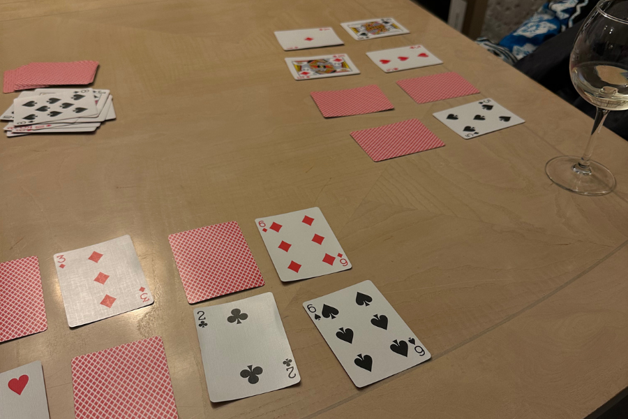 playing cards on table and a glass of wine 