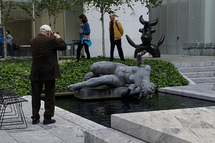 a man taking a picture of a sculpture